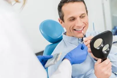 man deciding which color of dental veneers he wants for his teeth