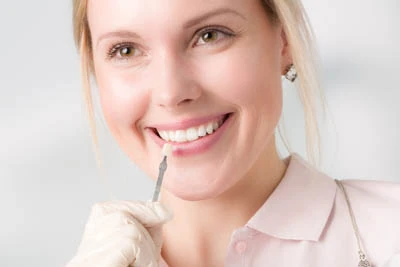 woman selecting a color for her new dental veneers